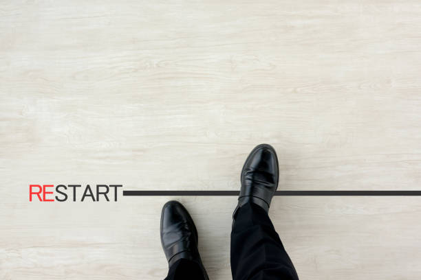 istock Business man stepping over restarting line 1363065337