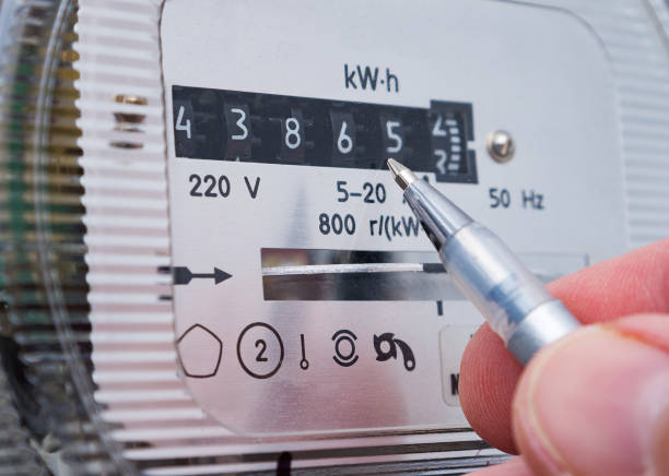 istock Ballpoint pen in person's hand showing electricity meter readings. 1363068480