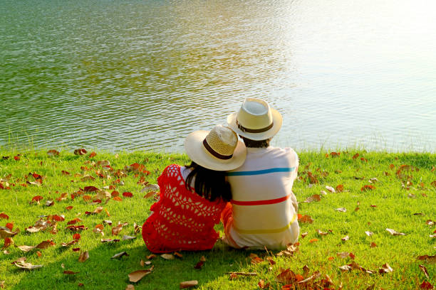 Couple in straw hat relaxing together on the lakeside, ( Self Portrait )