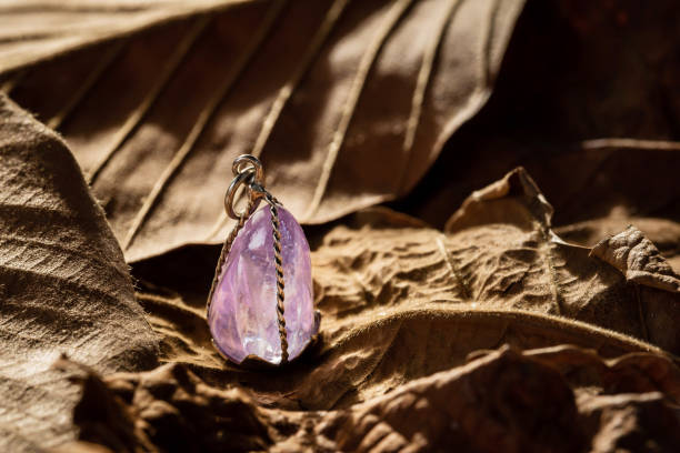istock The purple gemstone pendant with silver frame on leaf background. 1363069725