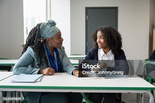 istock Black educator working with multiracial student in classroom 1363069809