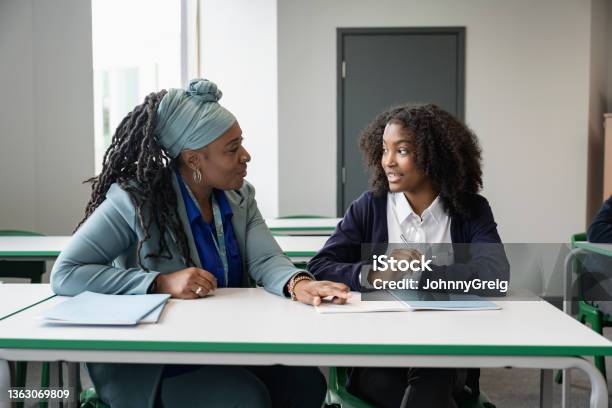 Black Educator Working With Multiracial Student In Classroom Stock Photo - Download Image Now