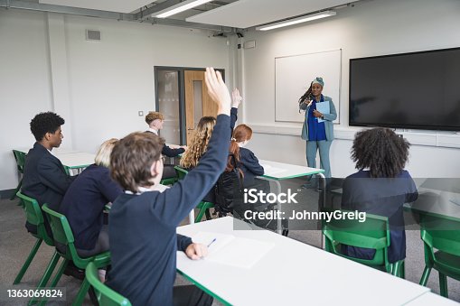 istock Teenage students interacting with teacher in classroom 1363069824