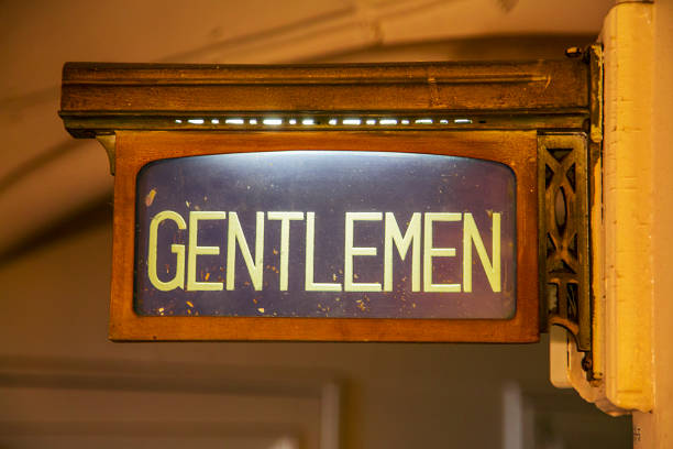 The blue men toilet symbol with brick wall in background.