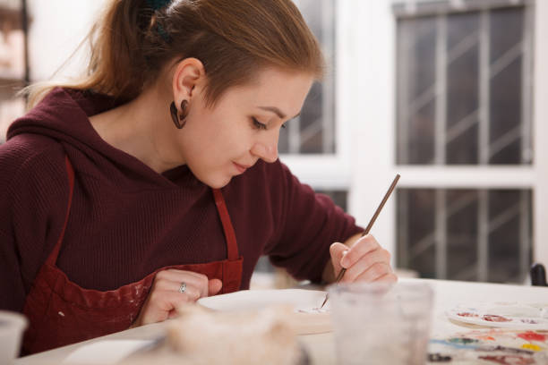istock Professional female potter at her workshop 1363074461