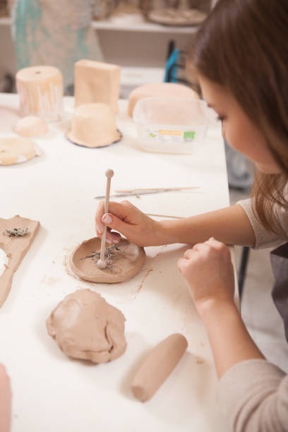 istock Young woman learning from professional potter 1363075397