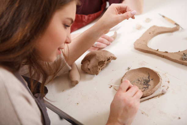 istock Young woman learning from professional potter 1363075521