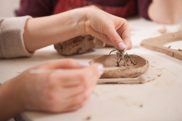 istock Young woman learning from professional potter 1363075634