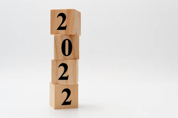 istock 2022 written on wooden blocks in vertical direction isolated on white background with copy space 1363076845