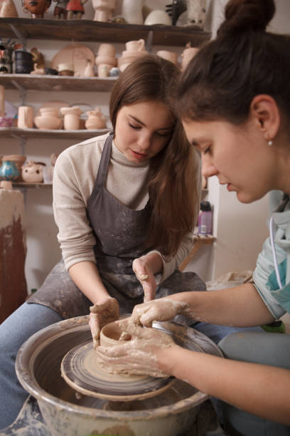 istock Young woman learning from professional potter 1363076846