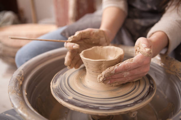 istock Woman throwing pots on potters wheel 1363077877