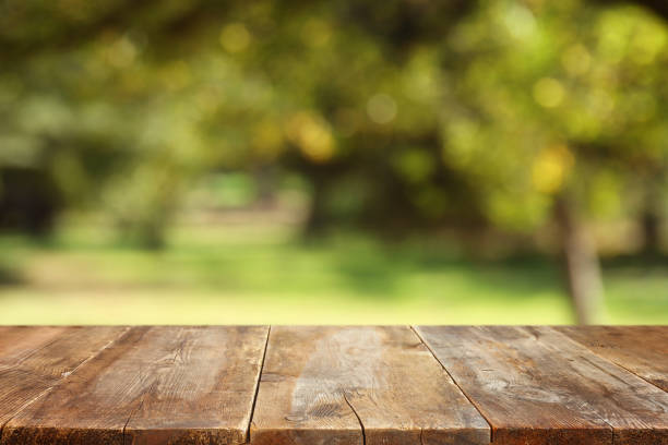 istock Empty rustic table in front of countryside background. product display and picnic concept 1363077917