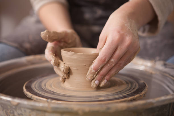 istock Woman throwing pots on potters wheel 1363077949