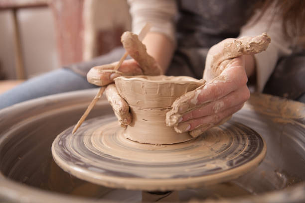 istock Woman throwing pots on potters wheel 1363078027