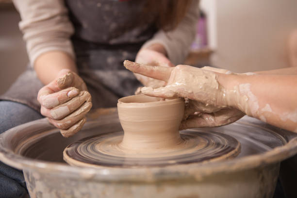 istock Young woman learning from professional potter 1363078088