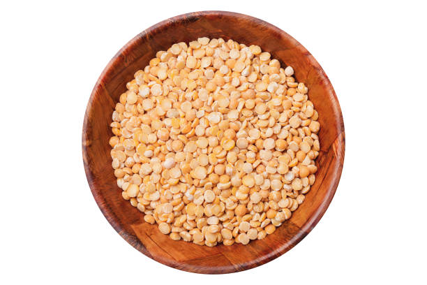 istock Dry split peas in wooden bowl isolated on white. 1363078551