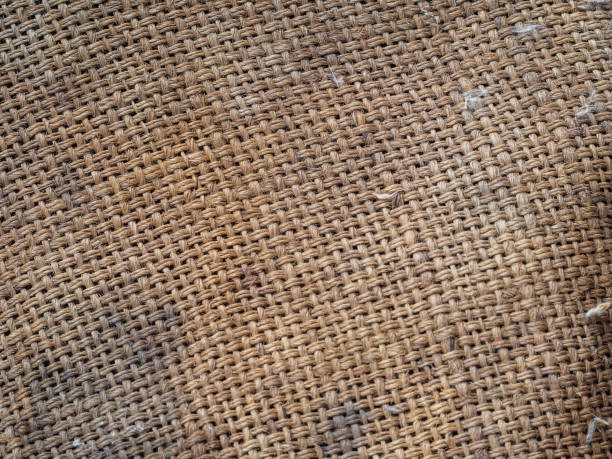 Old dirty burlap close-up. Textured burlap background. The texture of dirty old burlap. The structure of the braided thread web Old dirty burlap close-up. Textured burlap background. The texture of dirty old burlap. The structure of the braided thread web. linen flax textile burlap stock pictures, royalty-free photos & images