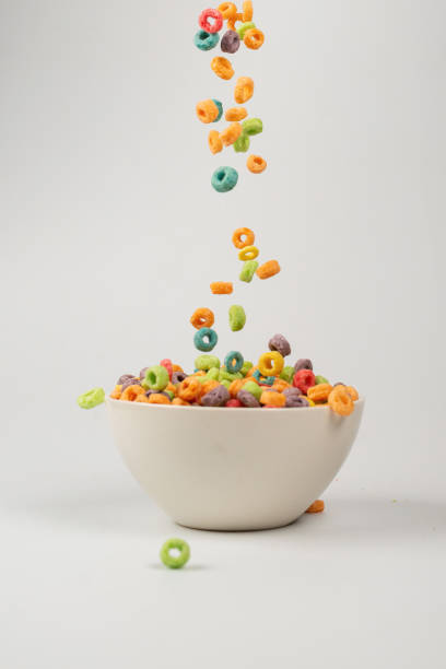 istock Colorful cereal box for morning breakfast. Corn flakes falling to the white bowl. Motion. 1363081216