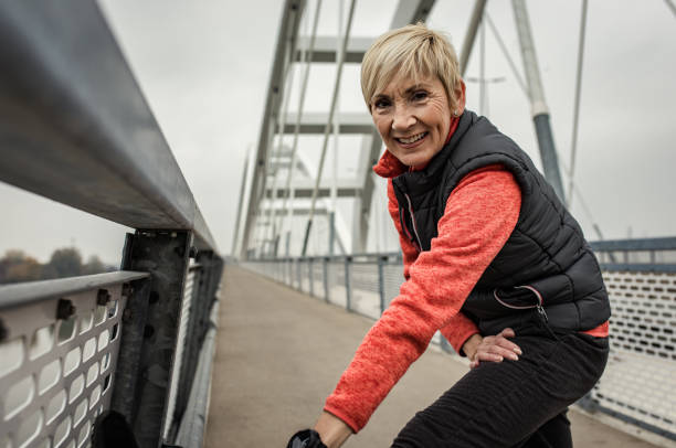 istock Active senior woman stretches her muscles before running. 1363082377
