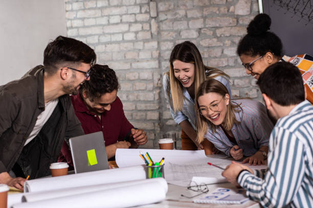 istock Group of young people discussing architectural designs in the creative office. 1363084352