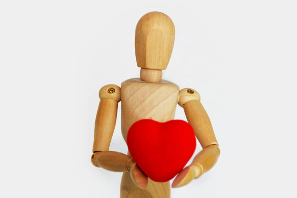 istock wooden mannequin holding a red heart 1363084712