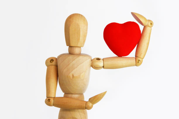 istock wooden mannequin holding a red heart 1363084721