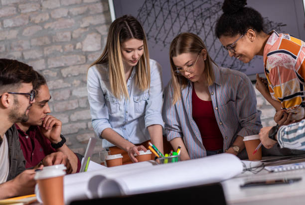 istock Group of young people discussing architectural designs in the creative office. 1363084722