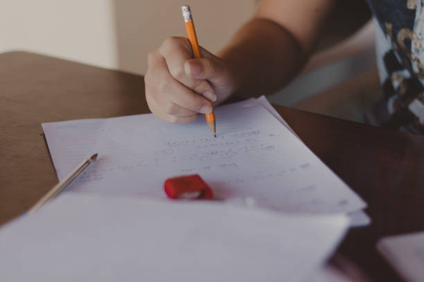 istock student doing homework on a wooden desk 1363084907