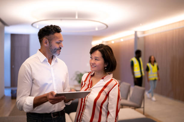 istock Businesspeople talking and using digital tablet at the office's lobby 1363086484