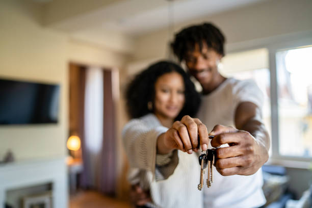 istock Two arms out holding keys 1363086711