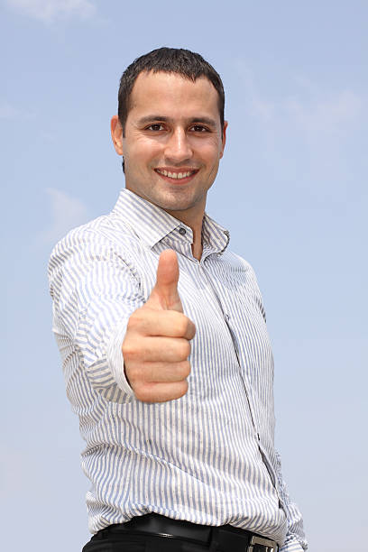 Smiling businessman showing ok stock photo