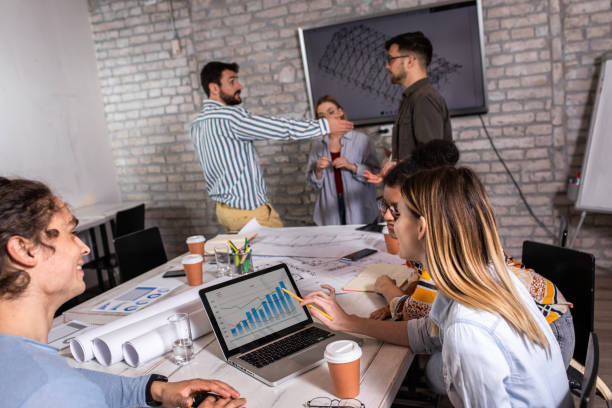 istock Group of young people discussing architectural designs in the creative office. 1363087663