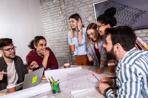 istock Group of young people discussing architectural designs in the creative office. 1363087694