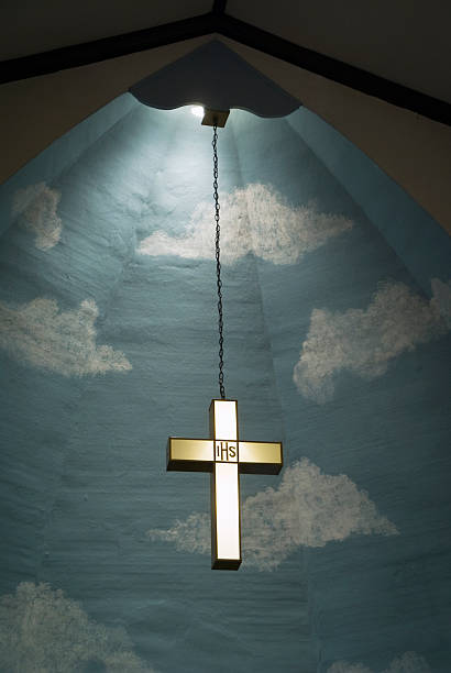 istock Illuminated Christian Cross Hanging in Sanctuary 136308826