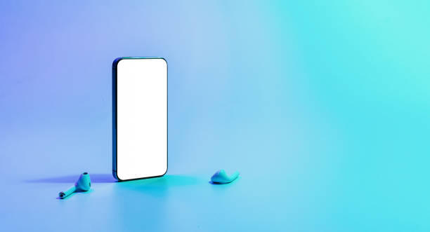 istock Screen mockup. Mobile smartphone technology blank screen. Mock up smart phone device, audio headphones on neon gradient banner. Game design, mobile application presentation or portfolio mockups. 1363090951