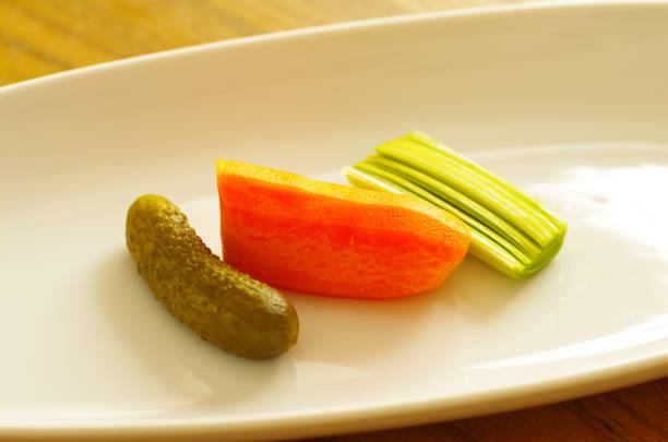 istock Pickle, carrot and leek on a white plate 1363091433