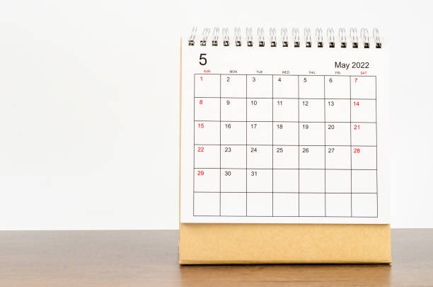 istock May 2022 desk calendar on wooden table. 1363092305