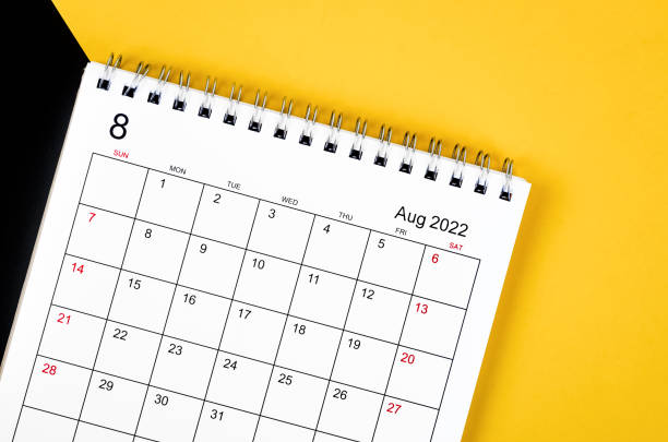 istock August 2022 desk calendar on yellow and black background. 1363092309
