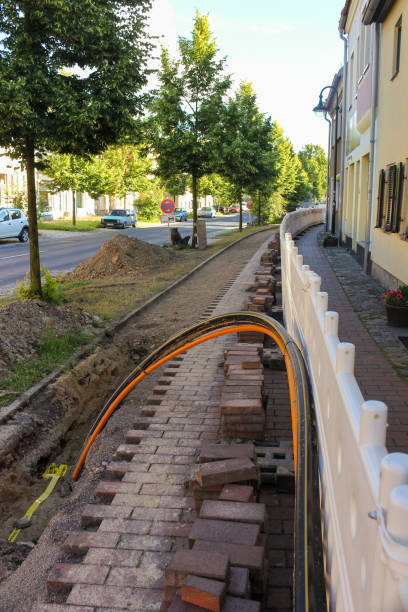 Civil engineering work on fiber optic expansion for fast Internet and DSL with a blockade on the cable duct on the footpath stock photo
