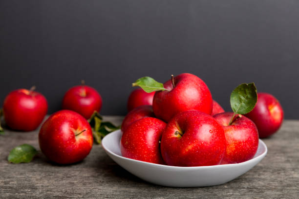 istock juicy red apples in a bowl or plate on the table top view. Copy space 1363096916