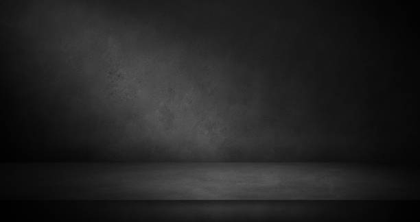 istock Dark concrete wall and floor background with light, three dimensional room for mock up or product display 1363096984