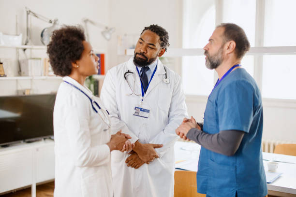 istock Multi-ethnic group of medical professionals  discuss about patient 1363097722