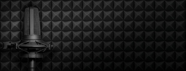 istock Dark podcast or recording studio background with acoustic foam and black microphone. Audio banner with copy space. 1363097771