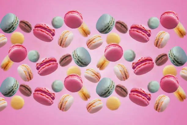 Macarons floating with pastel tone background.