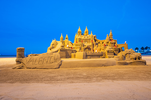 Sandcastle on the sand of a beach for child playing sand on the beach on summer holidays.