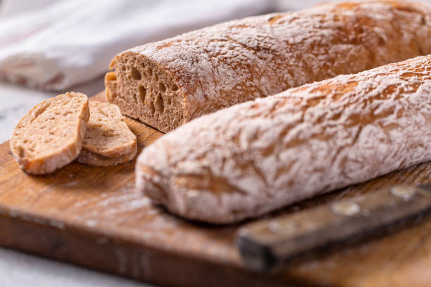 istock Rustic Italian Ciabatta Bread Loaves on Cutting Board 1363100463