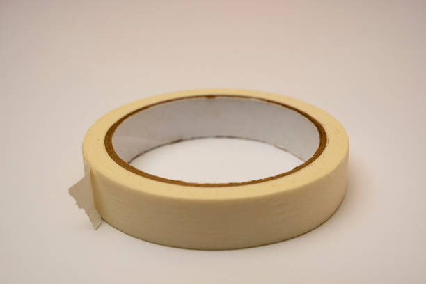 a roll of sticky adhesive tape on a white background stock photo