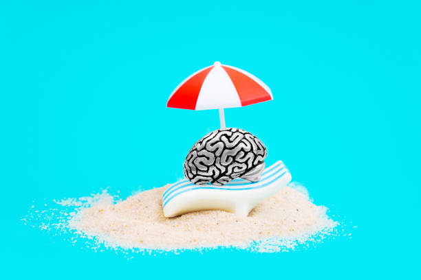 istock Steel brain relaxing under a sun umbrella by water 1363102346