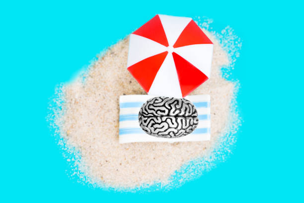 Human brain lying under a sun umbrella on a blue space