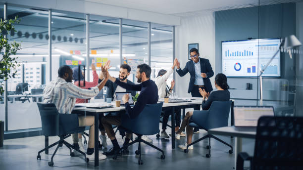 Multi-Ethnic Office Conference Room. Executive does Presentation for Young Managers. Team of Businesspeople Applaud, Celebrate Victorious Start of the Innovative e-Commerce Startup.